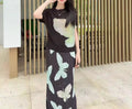 Summer women's outfit: a stylish two-piece set including a short-sleeved T-shirt and a pleated midi skirt with a slit.
